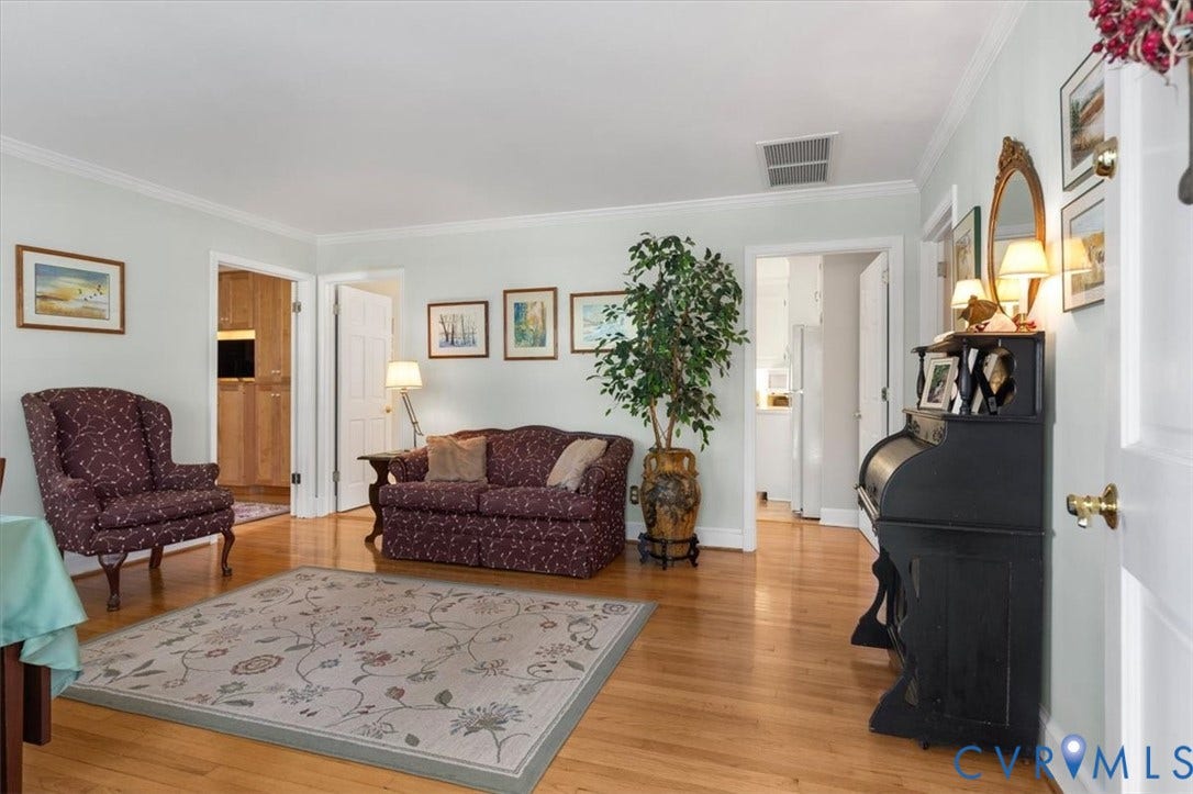 5111 Hurop Road, Sandston, VA 23150 Living area featuring polished wood-finish flooring and crown molding