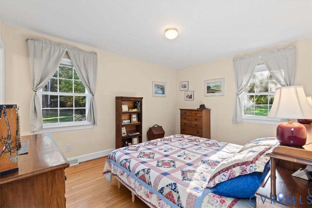 5111 Hurop Road, Sandston, VA 23150 Neutral interior space featuring wood-finish flooring, two multi-pane windows, and a ceiling-mounted light fixture