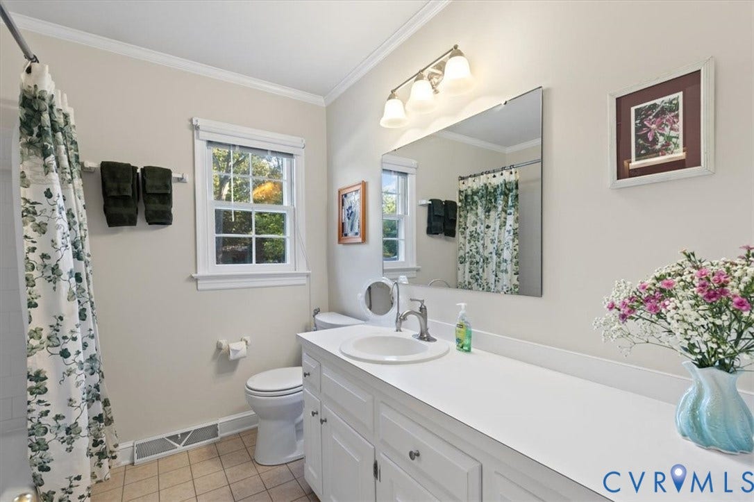 5111 Hurop Road, Sandston, VA 23150 Bathroom featuring a vanity with a white countertop and integrated sink, a frameless wall-mounted mirror, multi-light fixture, tile flooring, and a single-hung window