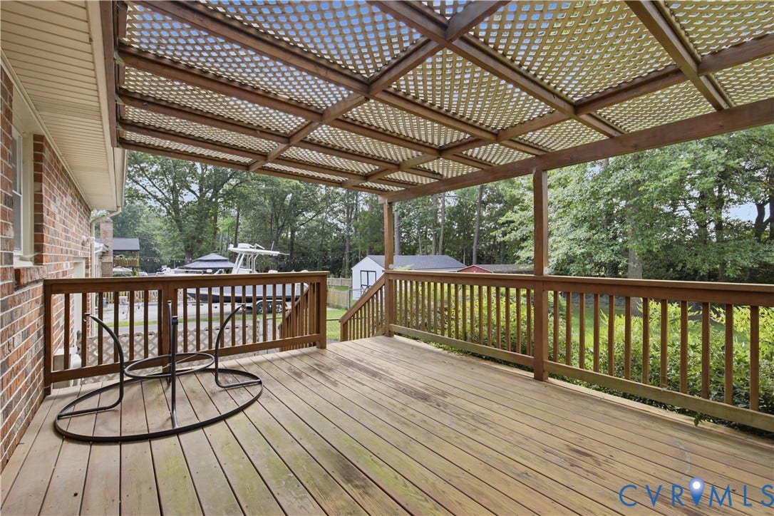 3641 Kiefer Road, Bermuda, Chester, VA 23831 Elevated wood deck featuring a lattice-style pergola cover, perimeter wood railing, and brick exterior wall