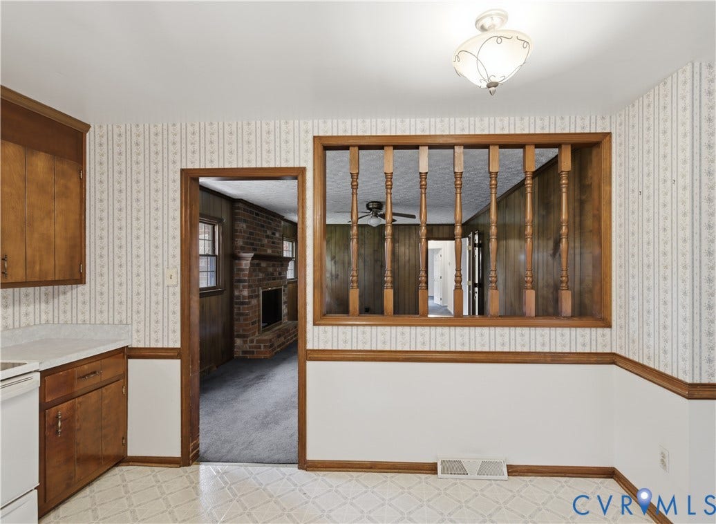 3641 Kiefer Road, Bermuda, Chester, VA 23831 Wood cabinetry, decorative interior balusters, brick fireplace, and patterned wall covering