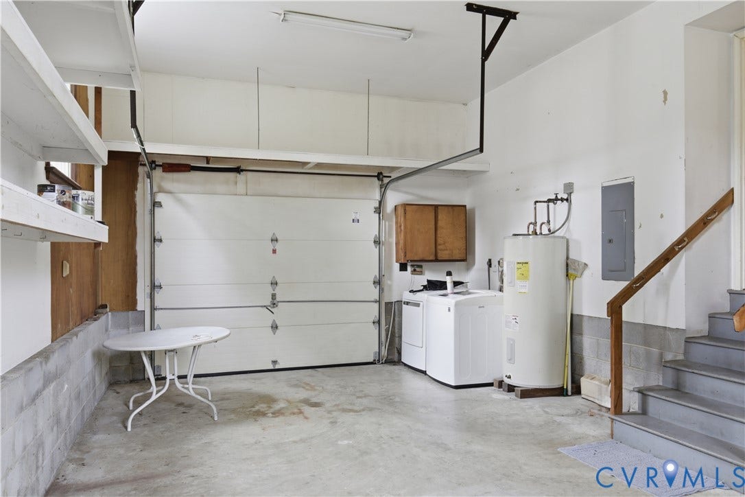 3641 Kiefer Road, Bermuda, Chester, VA 23831 Garage featuring a paneled sectional door, overhead storage shelving, laundry hookups, and integrated staircase with a wooden handrail
