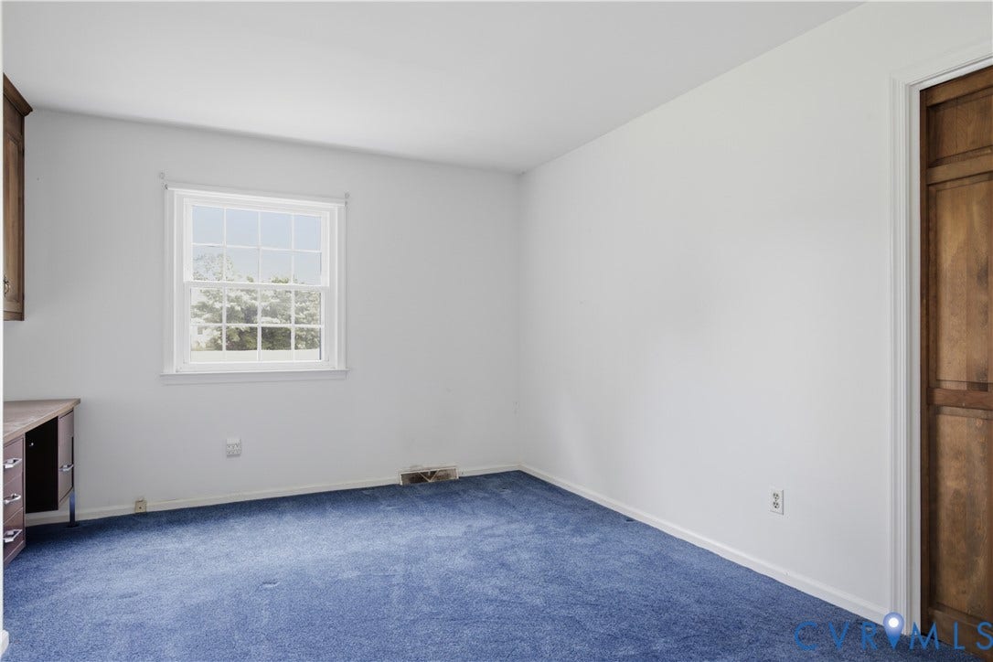 3641 Kiefer Road, Bermuda, Chester, VA 23831 Room featuring neutral wall finishes, carpeted flooring, a multi-pane window, and a built-in desk with wooden cabinetry