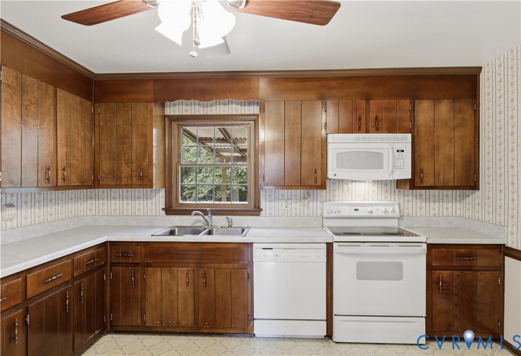3641 Kiefer Road, Bermuda, Chester, VA 23831 Kitchen featuring wood cabinetry, solid-surface countertops, dual-basin sink, and integrated white appliances including a range, microwave, and dishwasher