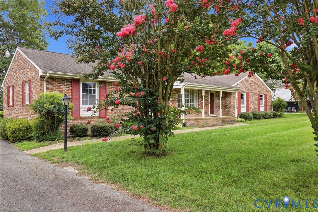3641 Kiefer Road, Bermuda, Chester, VA 23831 Brick exterior featuring shuttered windows, covered front porch, asphalt driveway, and mature landscaping