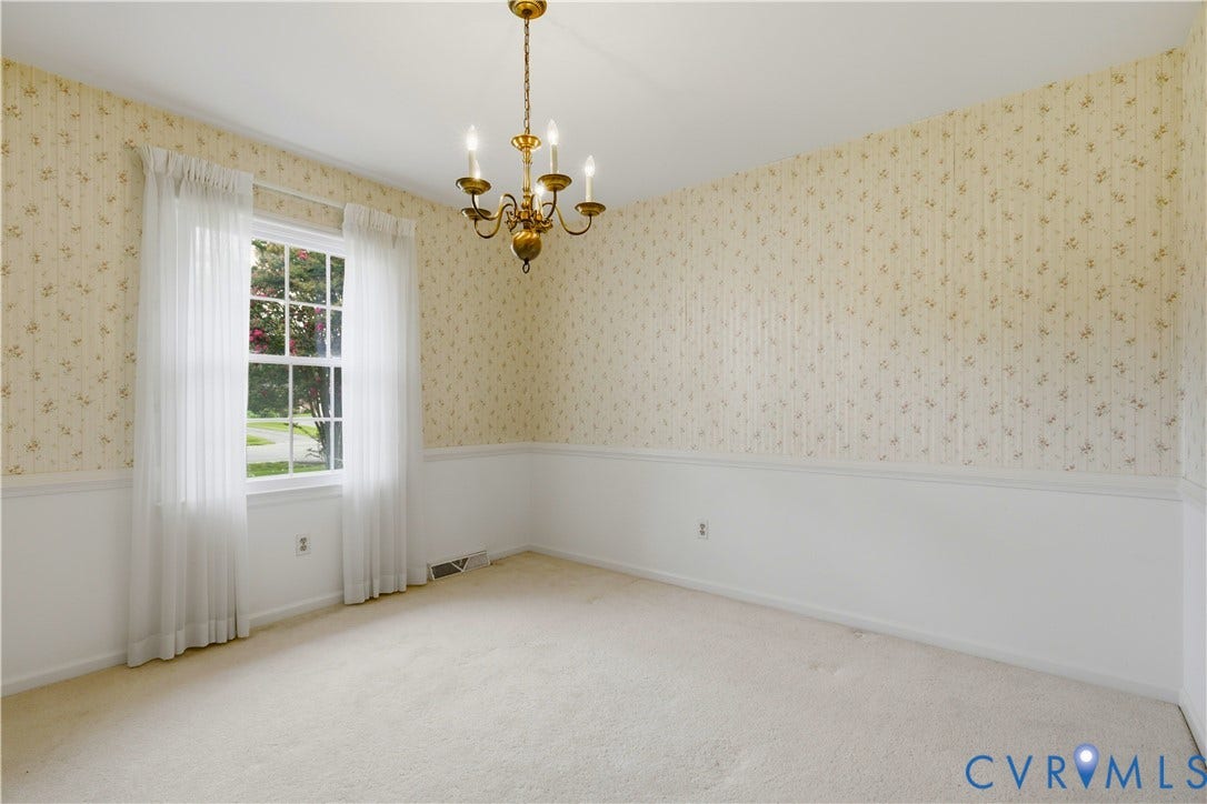 3641 Kiefer Road, Bermuda, Chester, VA 23831 Multi-pane window with white trim, floral patterned wallpaper, chair rail molding, and brass-finish multi-arm chandelier