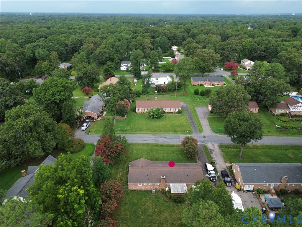 3641 Kiefer Road, Bermuda, Chester, VA 23831 Aerial perspective featuring a brick exterior residence, asphalt shingle roof, masonry chimney, and expansive surrounding greenery