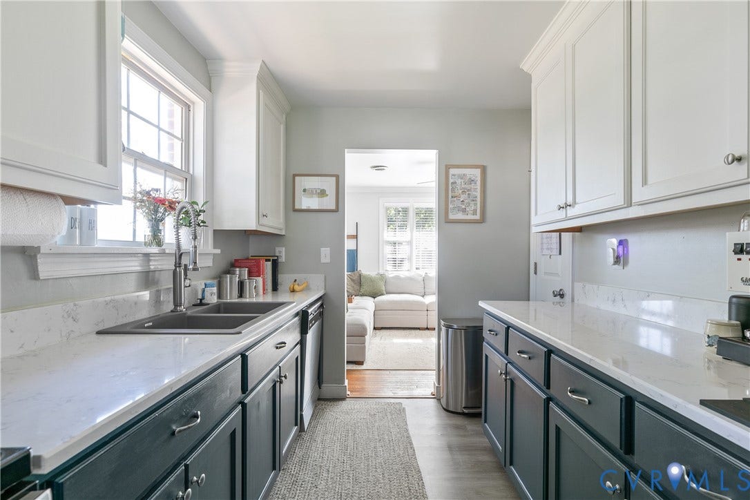 2108 Parkside Avenue, Henrico, VA 23228 Kitchen featuring dual-toned cabinetry, quartz countertops, a double-basin stainless steel sink with a high-arch faucet, and wood-finish flooring