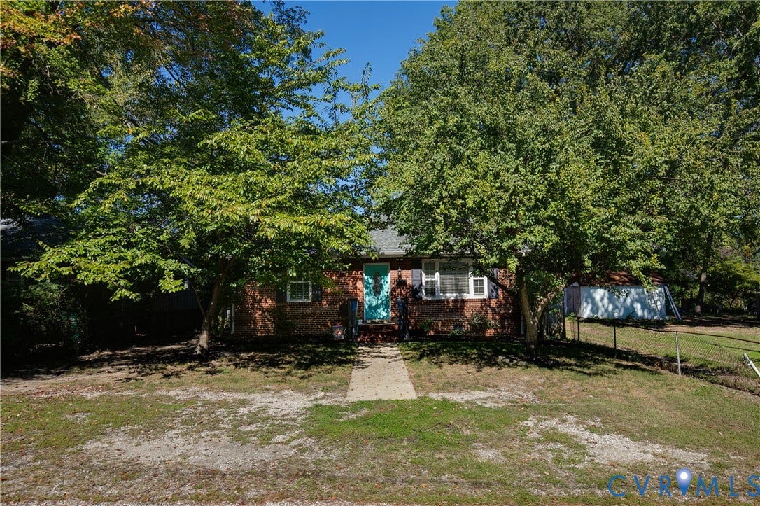 2108 Parkside Avenue, Henrico, VA 23228 Brick exterior featuring a concrete walkway, shuttered windows, and mature trees