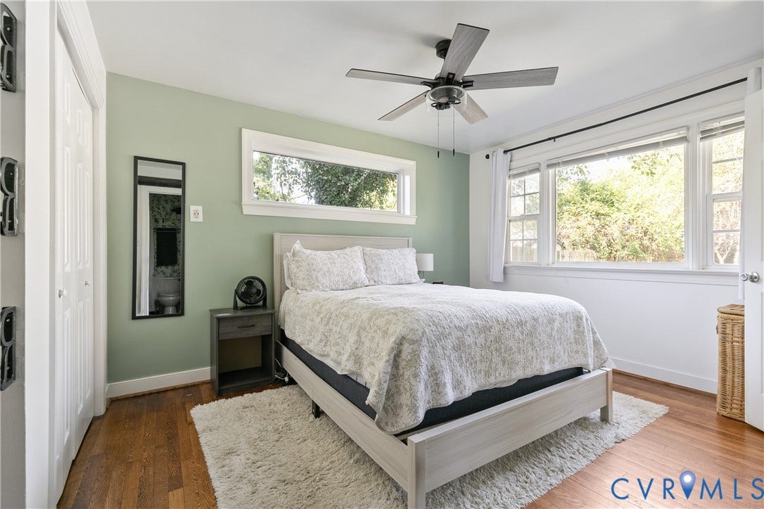 2108 Parkside Avenue, Henrico, VA 23228 Wood-finish flooring, ceiling fan with integrated lighting, expansive multi-pane windows, and high-contrast dual-panel closet doors