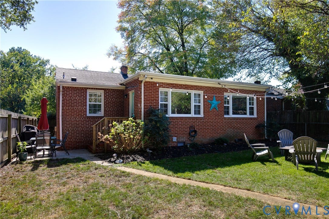 2108 Parkside Avenue, Henrico, VA 23228 Red brick exterior with white-framed windows, a wood deck, and a fenced backyard
