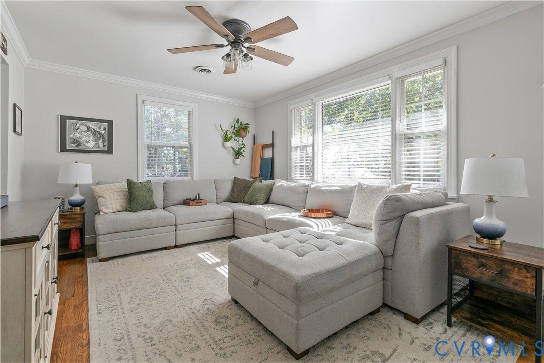 2108 Parkside Avenue, Henrico, VA 23228 Living space featuring wood-finish flooring, multi-pane windows with white casing, and a ceiling fan with integrated lighting