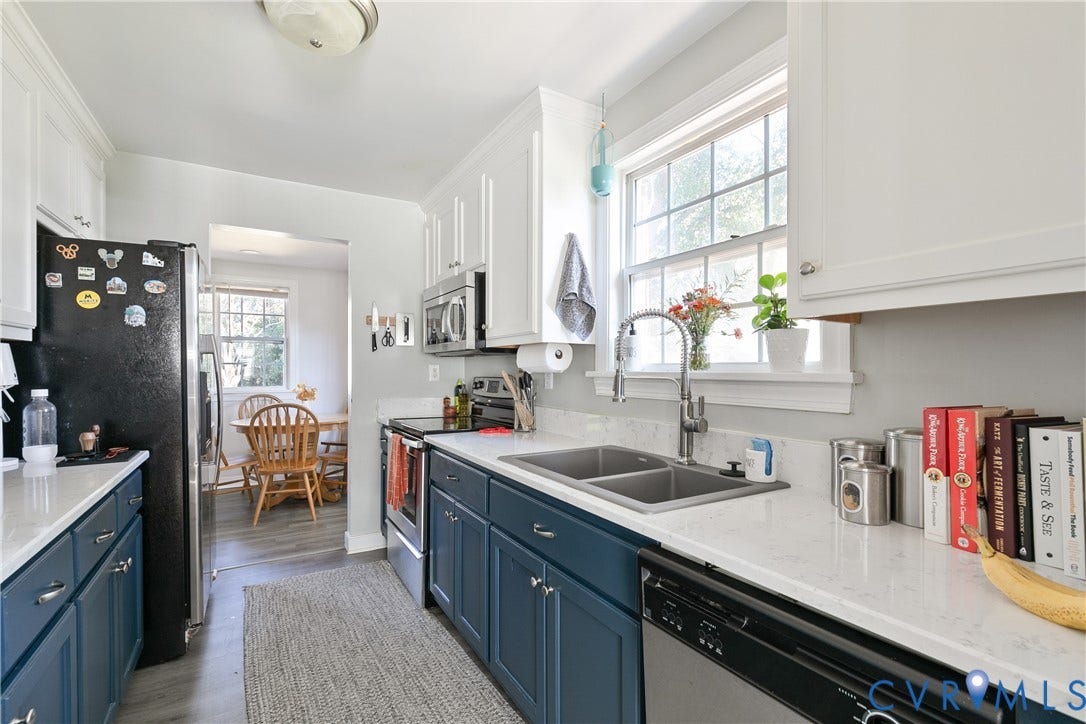 2108 Parkside Avenue, Henrico, VA 23228 Kitchen featuring two-tone shaker-style cabinetry, solid-surface countertops, dual-basin under-mount stainless steel sink with high-arch faucet, and stainless steel appliances