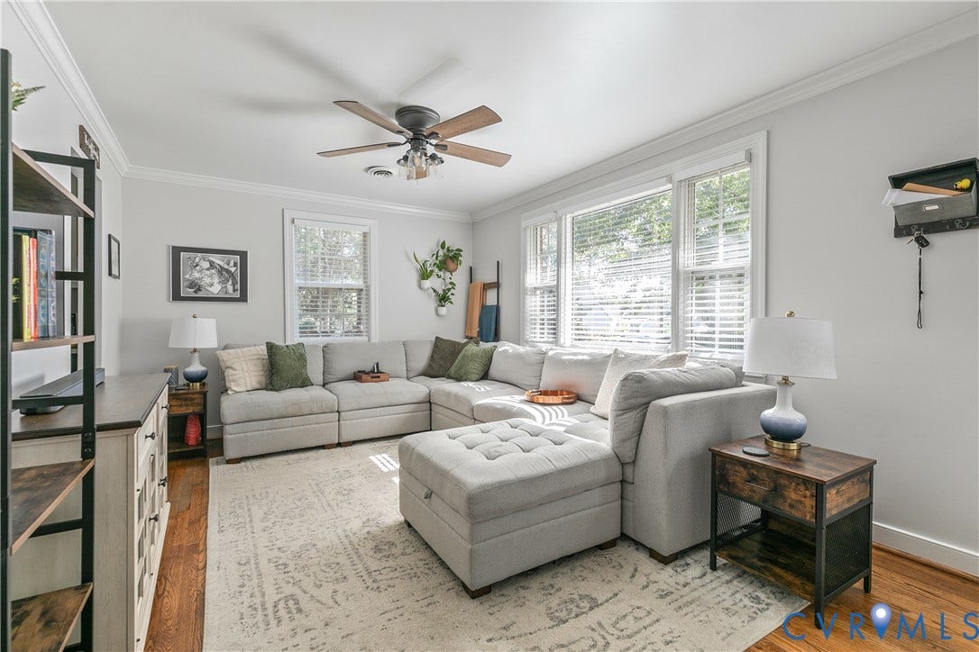 2108 Parkside Avenue, Henrico, VA 23228 Hardwood flooring, crown molding, ceiling fan with light fixture, and multiple windows with horizontal blinds