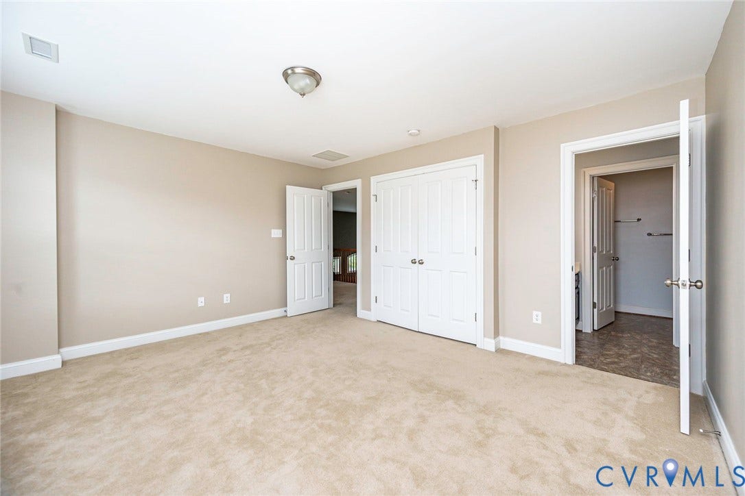 9118 Colonnade Circle, Ashland, VA 23005 Neutral-toned room featuring neutral wall-to-wall carpeting, double-panel interior doors, a double-door closet, and overhead flush-mount lighting