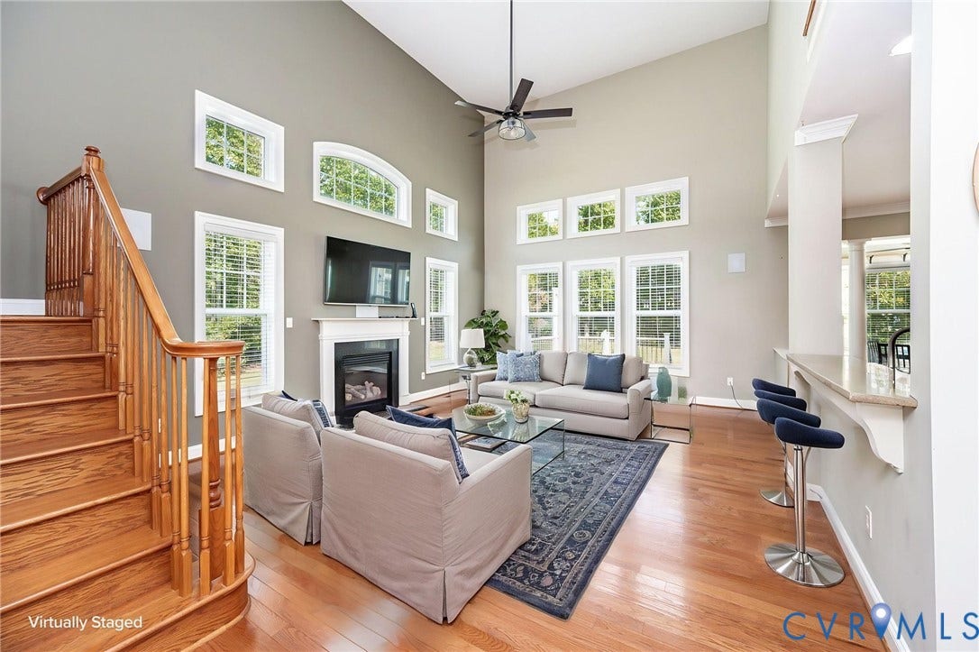 9118 Colonnade Circle, Ashland, VA 23005 Vaulted ceilings, fireplace with mantel, wood-finish flooring, staircase with wooden balustrade, and breakfast bar