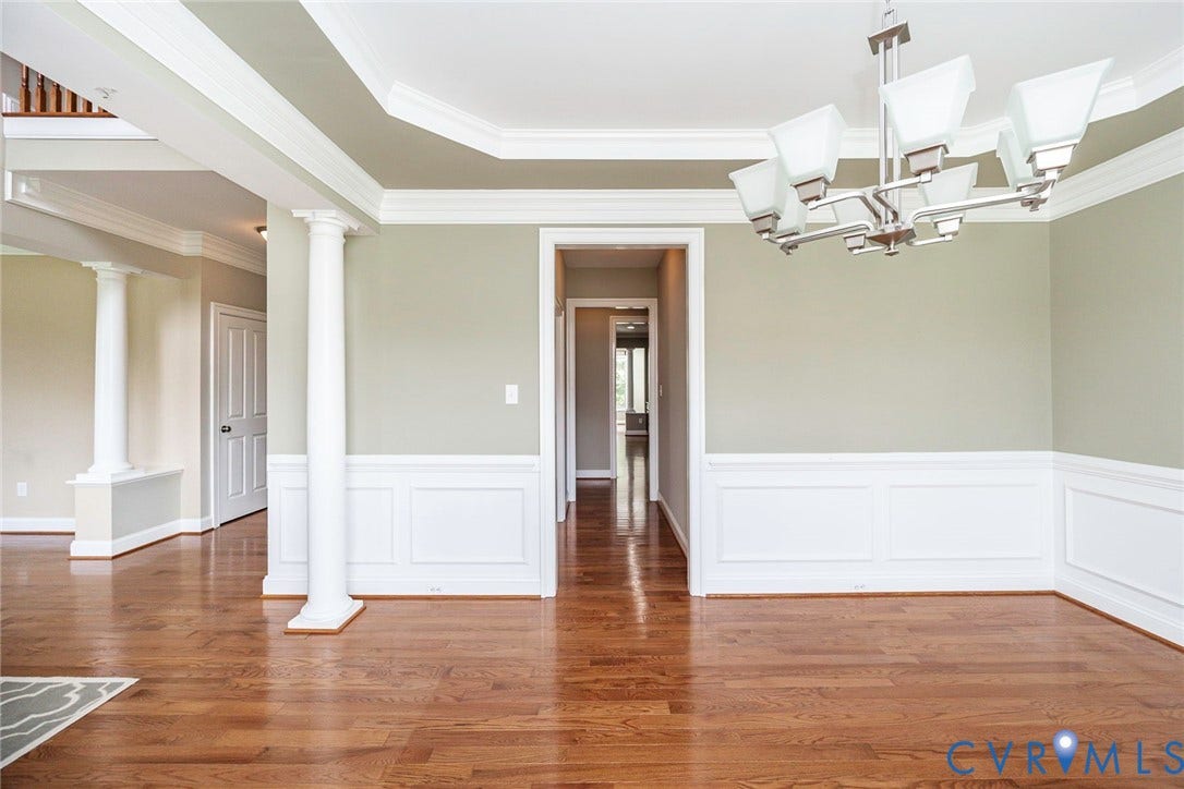 9118 Colonnade Circle, Ashland, VA 23005 Hardwood flooring, crown molding, chair rail wainscoting, decorative columns, and a multi-arm chandelier