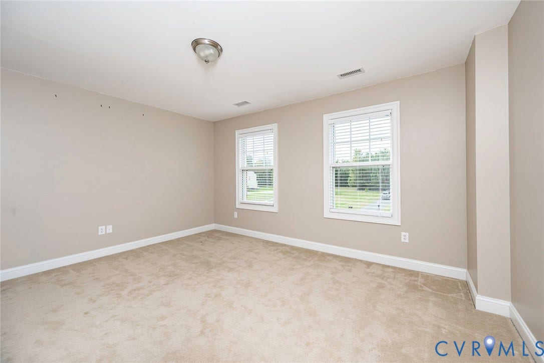 9118 Colonnade Circle, Ashland, VA 23005 Neutral-toned room featuring wall-to-wall carpeting, dual windows with integrated blinds, and a flush-mount ceiling fixture