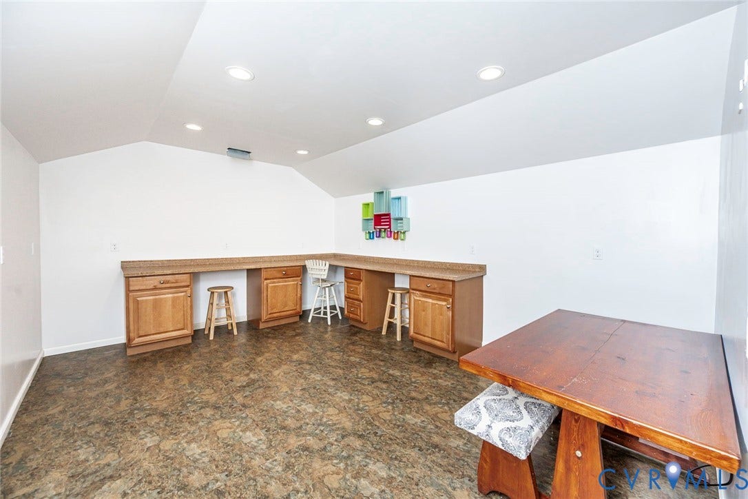 9118 Colonnade Circle, Ashland, VA 23005 Built-in wooden cabinetry featuring stone-finish countertops, recessed ceiling lighting, and hard-surface flooring under a vaulted ceiling