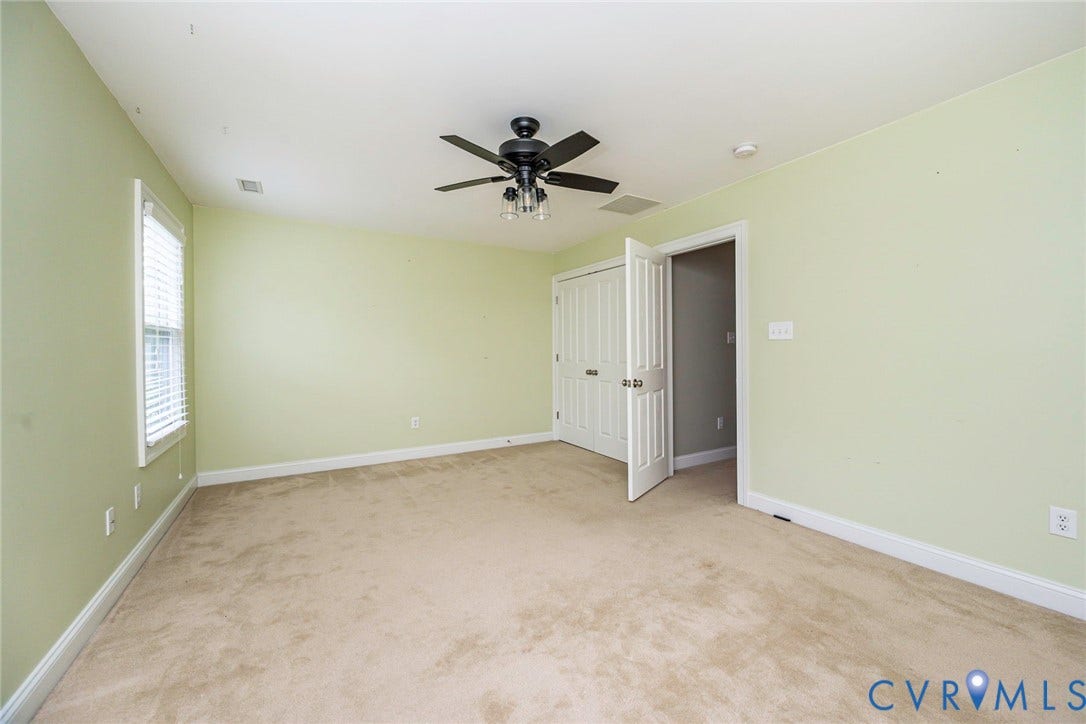 9118 Colonnade Circle, Ashland, VA 23005 Room featuring neutral carpeting, double-door closet, multi-blade ceiling fan with integrated lighting, and window with blinds