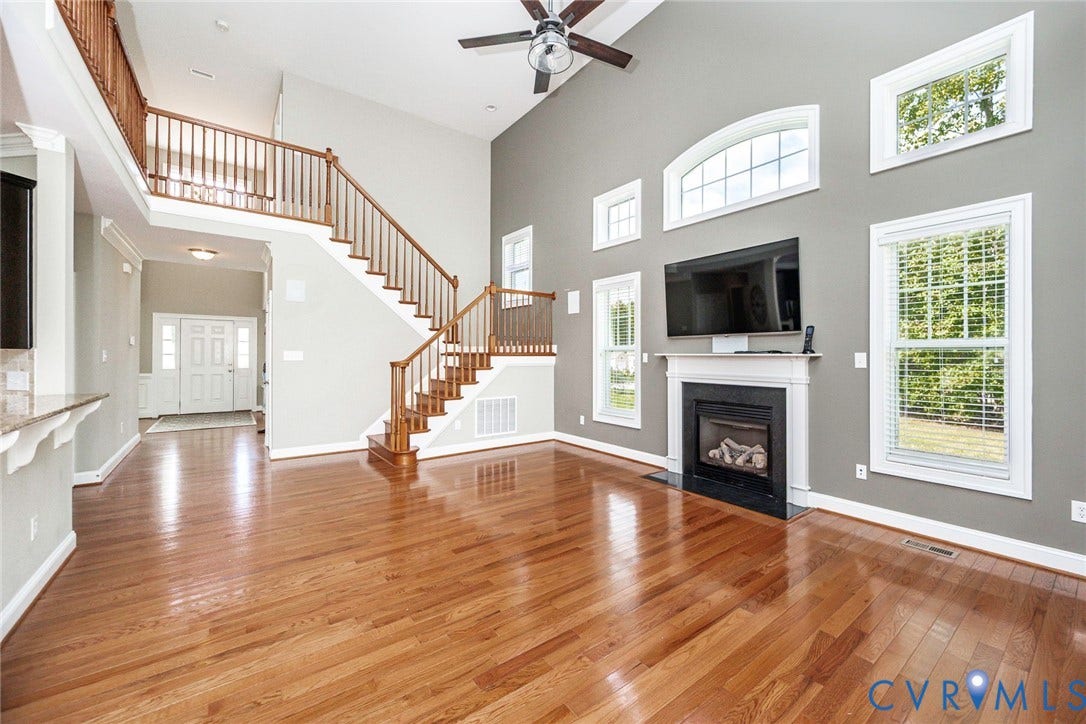 9118 Colonnade Circle, Ashland, VA 23005 Vaulted ceilings, wood-finish flooring, fireplace with a mantle, wood-railing staircase, and tiered windows