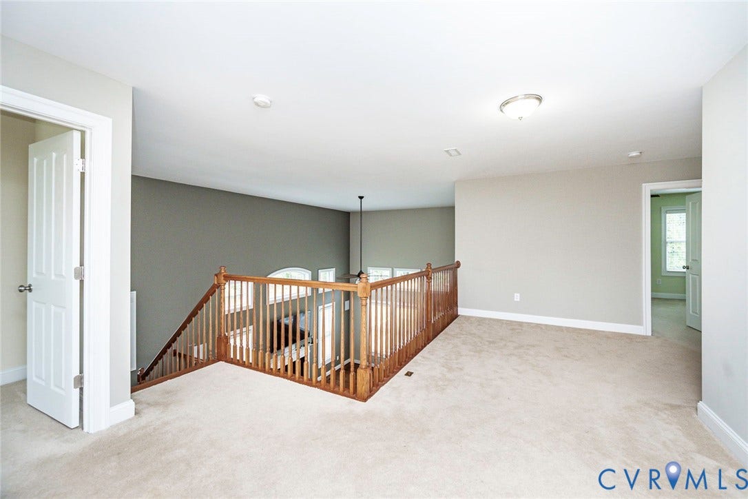 9118 Colonnade Circle, Ashland, VA 23005 Neutral carpeted flooring, wood balustrade railing, dual-tone wall color, flush-mount lighting, and multi-panel interior doors