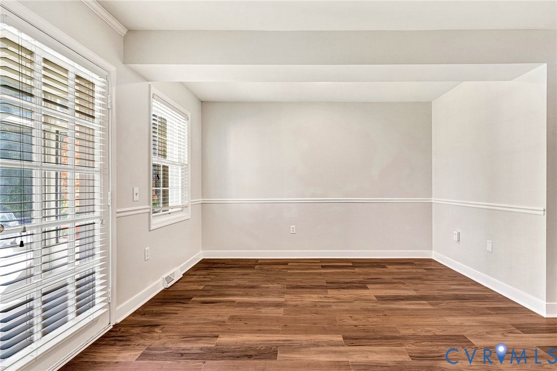 4 Millstone Road, The Hamlet, Henrico, VA 23228 Neutral-toned interior space featuring wood-finish flooring, white chair rail molding, and a full-length glass door with integrated blinds