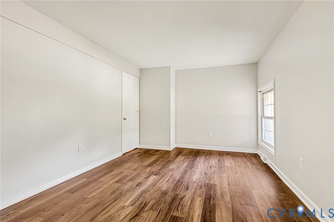 4 Millstone Road, The Hamlet, Henrico, VA 23228 Neutral-toned walls, wood-finish flooring, and a multi-pane window with a white frame