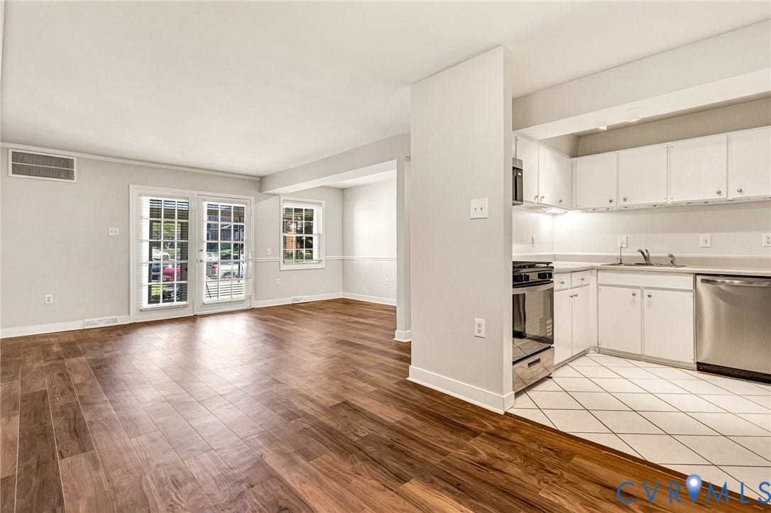 4 Millstone Road, The Hamlet, Henrico, VA 23228 Kitchen featuring white cabinetry, stainless steel appliances, and tile flooring, with wood-finish flooring in the surrounding space and double glass-paned doors