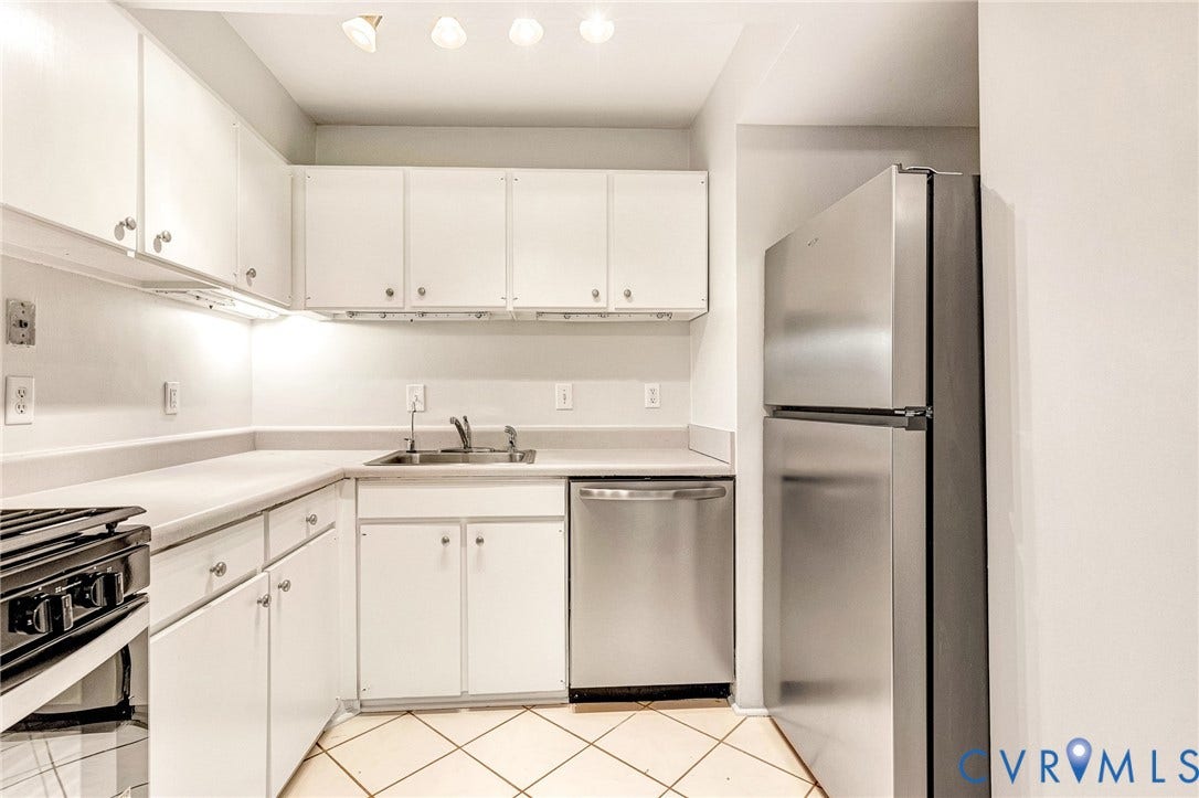 4 Millstone Road, The Hamlet, Henrico, VA 23228 Kitchen featuring white cabinetry, stainless steel refrigerator and dishwasher, solid-surface countertops, and diagonal tile flooring
