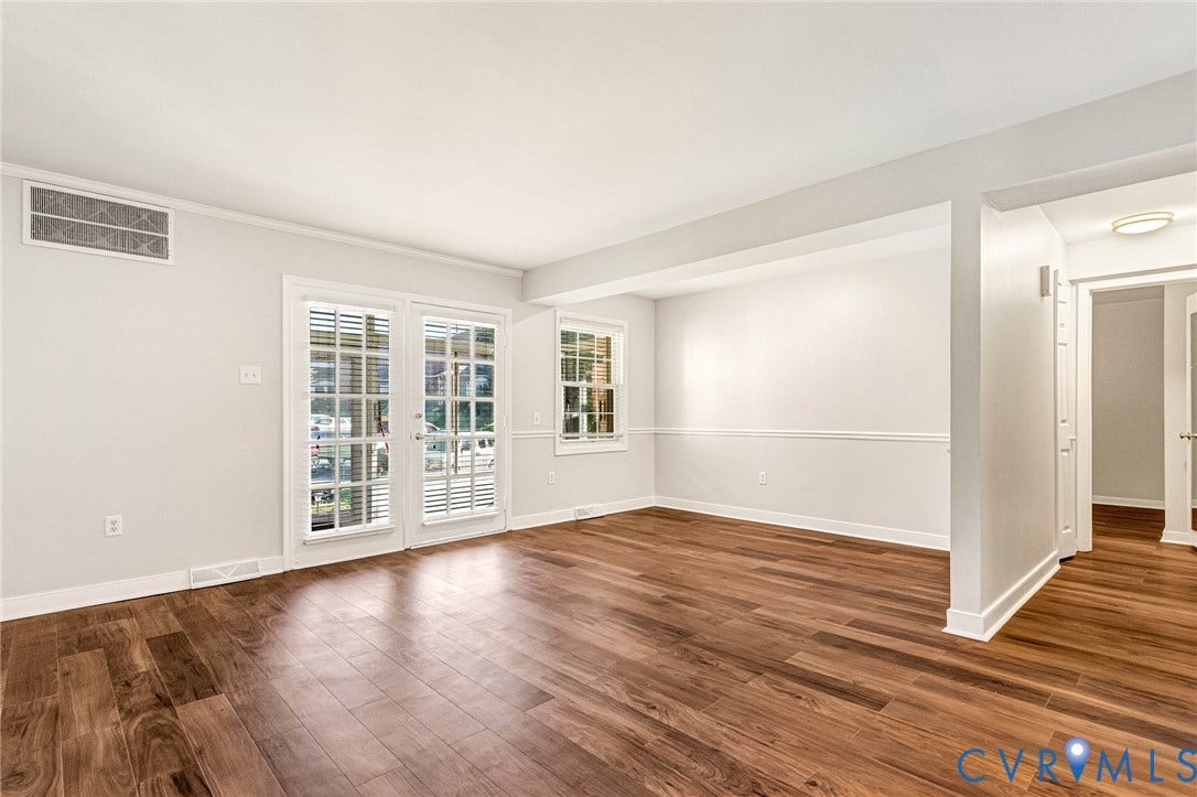 4 Millstone Road, The Hamlet, Henrico, VA 23228 Living area featuring wood-finish flooring, double glass-panel doors, chair rail molding, and a multi-pane window