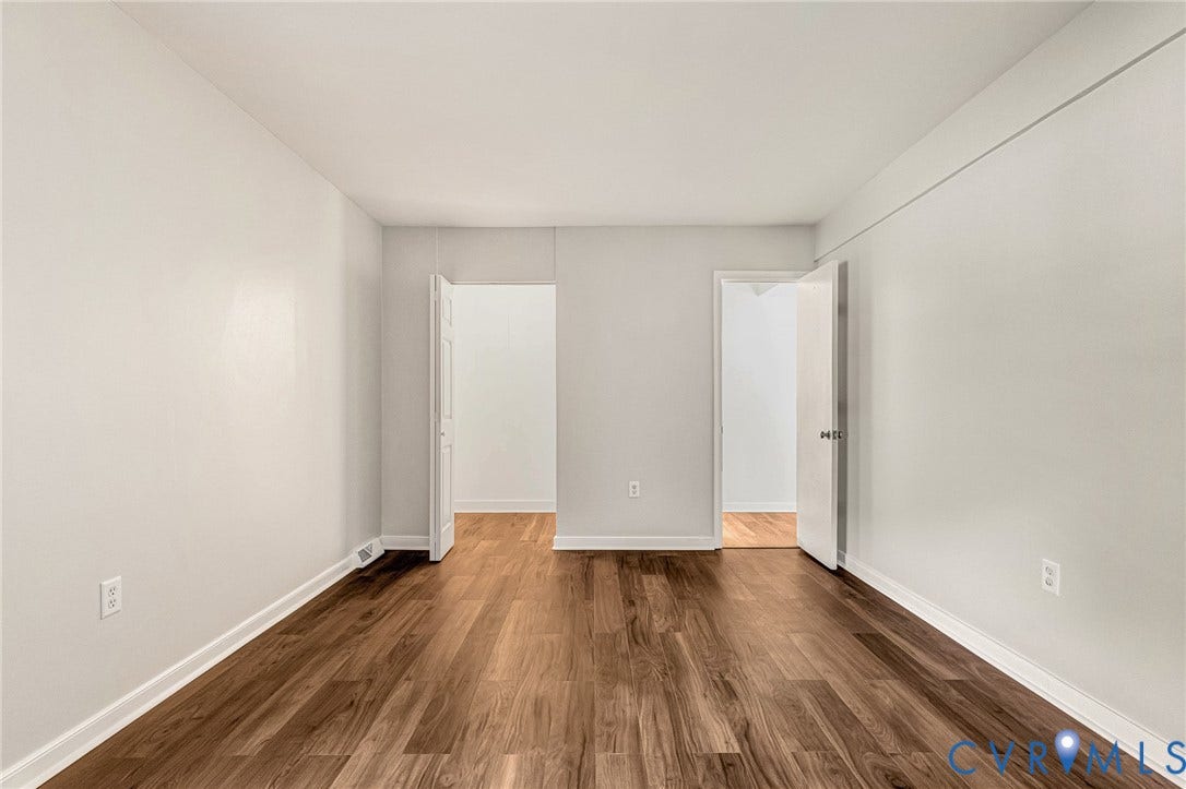 4 Millstone Road, The Hamlet, Henrico, VA 23228 Neutral wall color, wood-finish flooring, and two interior doorways with traditional panel doors