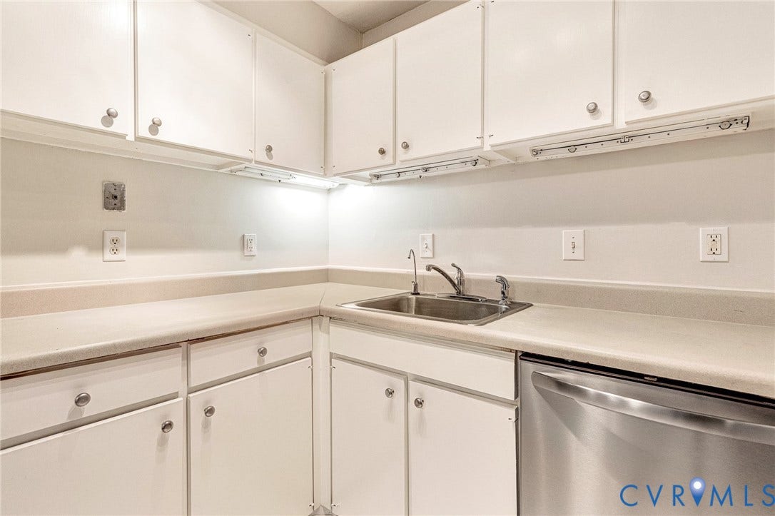 4 Millstone Road, The Hamlet, Henrico, VA 23228 White cabinetry with brushed nickel hardware, solid surface countertops, stainless steel sink with a high-arch faucet, and an integrated stainless steel dishwasher