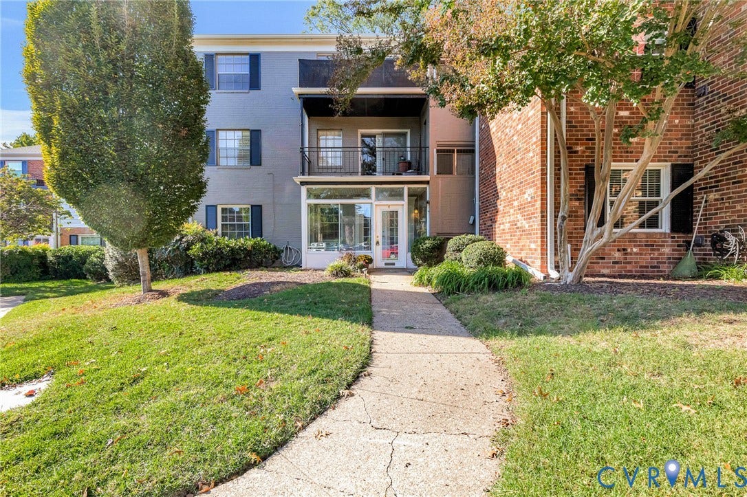 4 Millstone Road, The Hamlet, Henrico, VA 23228 Multi-story exterior featuring a combination of painted masonry and red brick cladding, an enclosed lower-level sunroom, and an upper-level balcony with metal railings