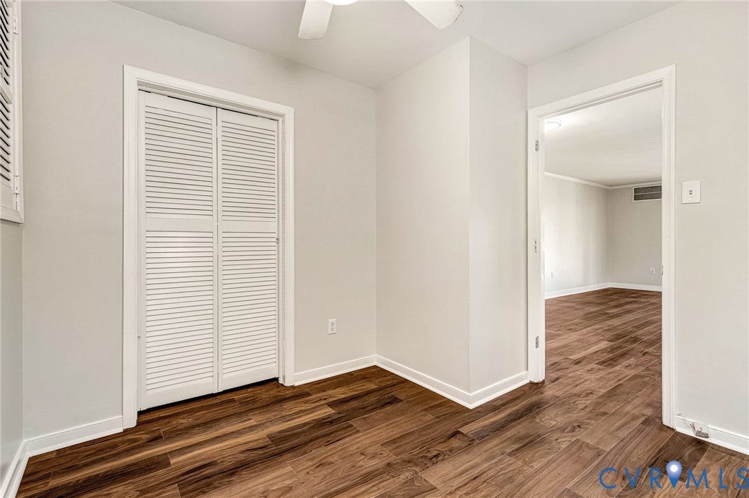 4 Millstone Road, The Hamlet, Henrico, VA 23228 Neutral-toned interior featuring wood-finish flooring, a white ceiling fan, and a closet with bifold louvered doors