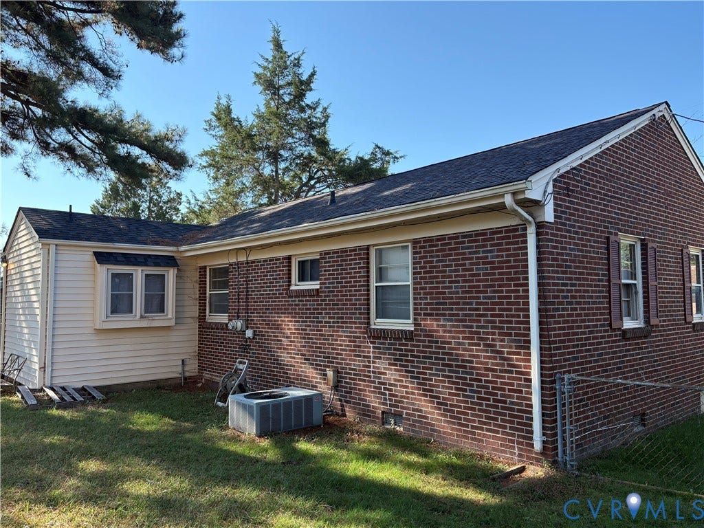 106 Verbov Avenue, Lundsford, Colonial Heights, VA 23834 Exterior featuring classic brick and horizontal siding, a gabled roofline, double-hung windows, and a fenced yard area
