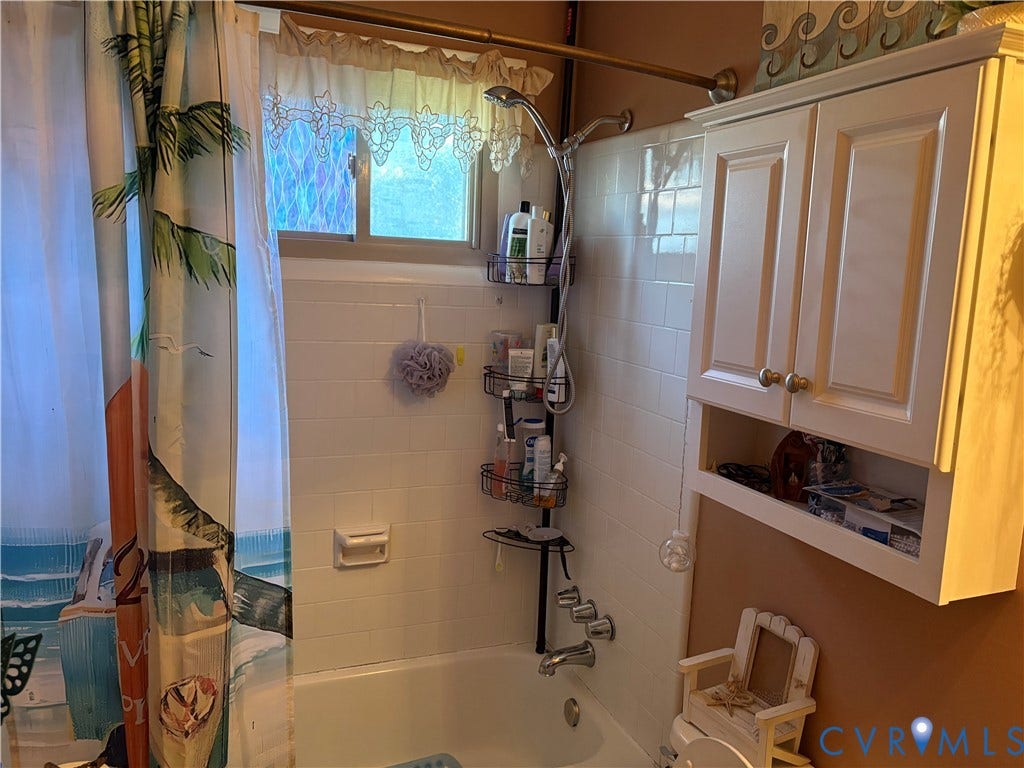 106 Verbov Avenue, Lundsford, Colonial Heights, VA 23834 Bathtub featuring white subway-style wall tile, built-in soap dish, and a white wall-mounted cabinet with integrated shelving