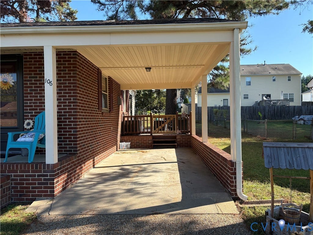 106 Verbov Avenue, Lundsford, Colonial Heights, VA 23834 Brick exterior featuring a covered carport, concrete driveway, and elevated wood deck with perimeter railing