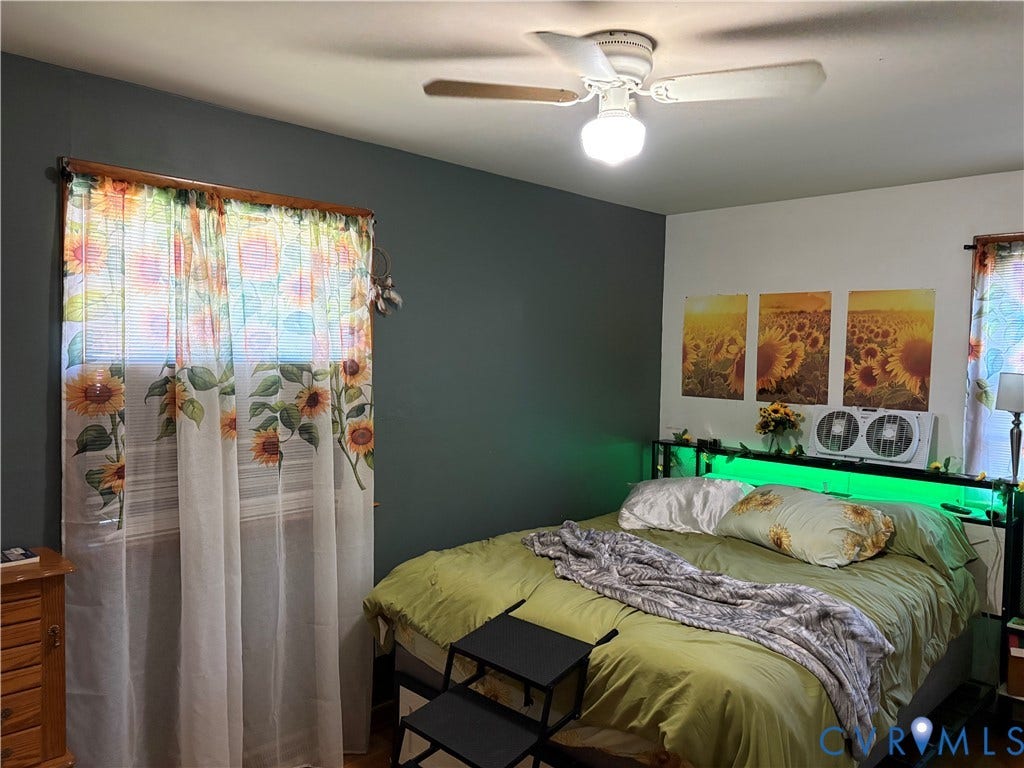 106 Verbov Avenue, Lundsford, Colonial Heights, VA 23834 Room featuring dark-toned accent wall, ceiling fan with integrated lighting, and dual windows