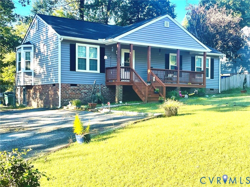 11801 New Forest Court, Chesterfield, VA 23112 Single-story residence featuring blue horizontal siding, a red brick foundation, a bay window, and an elevated wood-deck front porch