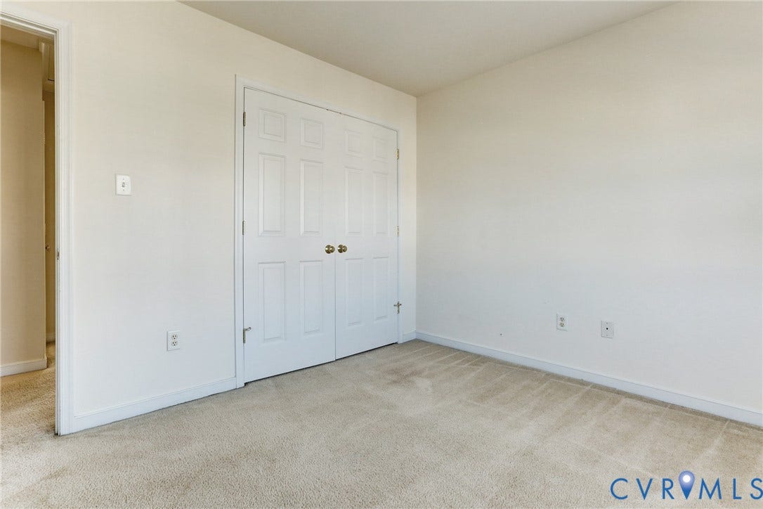 Neutral wall finishes, carpeting, and double-door closet