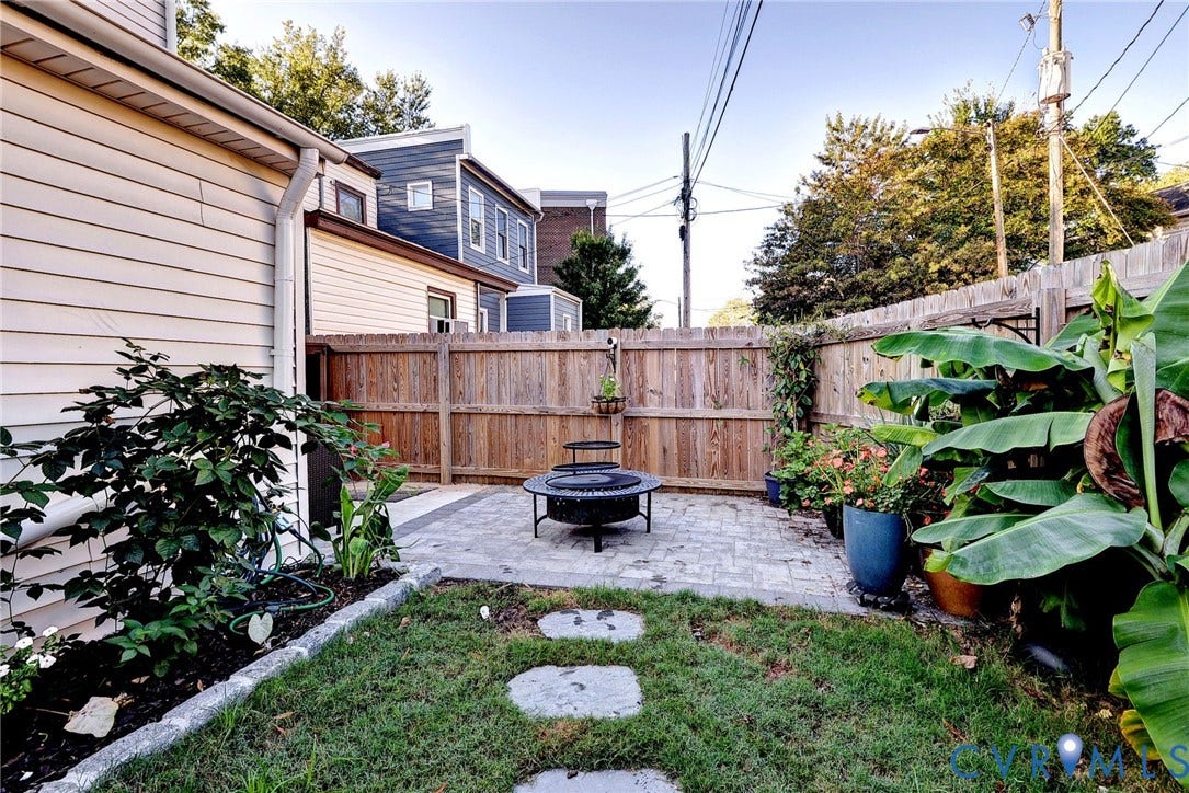730 N 23RD Street, Union Hill, Richmond, VA 23223 Private outdoor area featuring a stone paver patio, natural stone pavers, and a wooden privacy fence