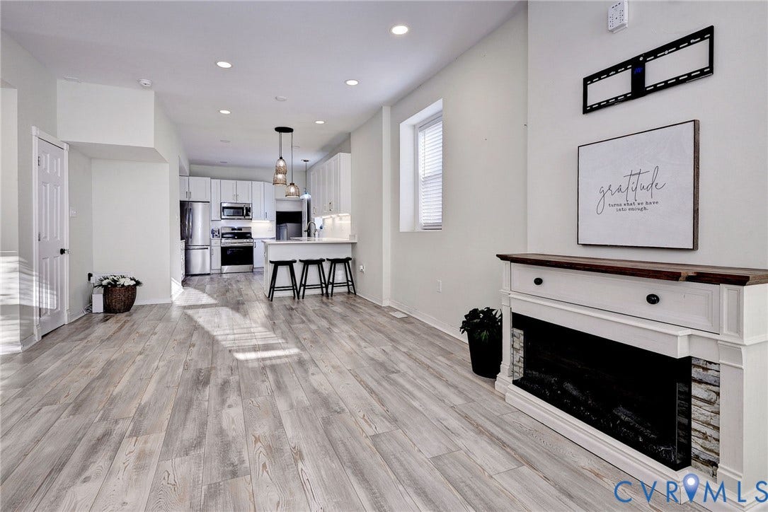 730 N 23RD Street, Union Hill, Richmond, VA 23223 Light filled open-concept room with recessed lighting, an electric fireplace, and LVP flooring.