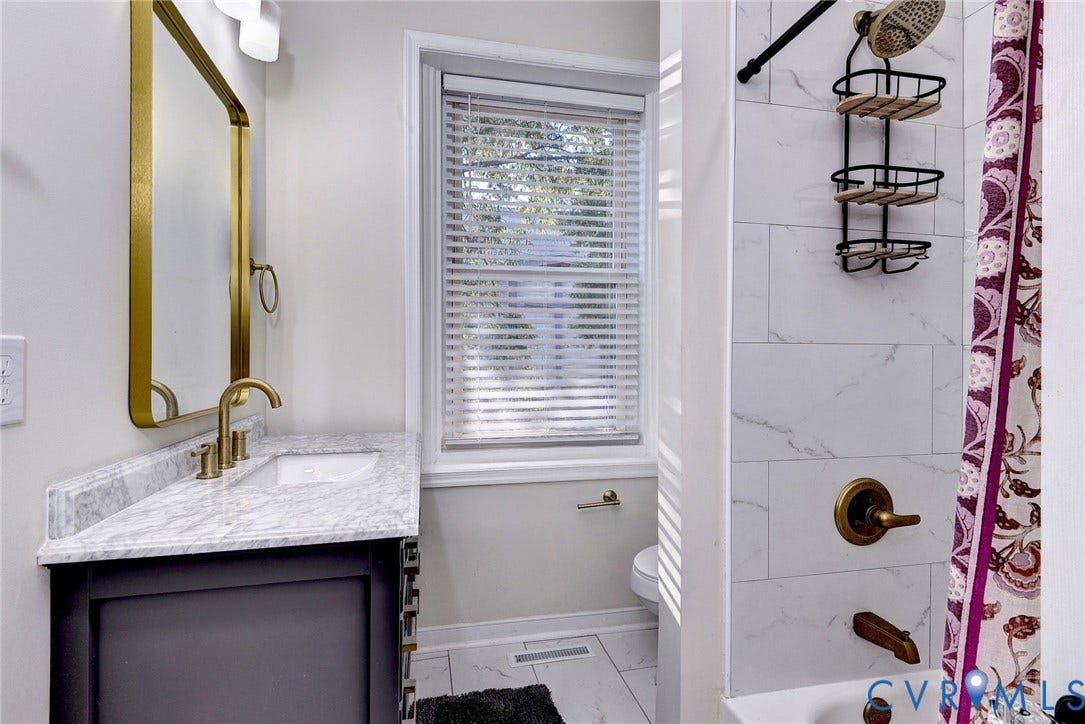 730 N 23RD Street, Union Hill, Richmond, VA 23223 Hall Bath with tub/shower combo and brass accents.
