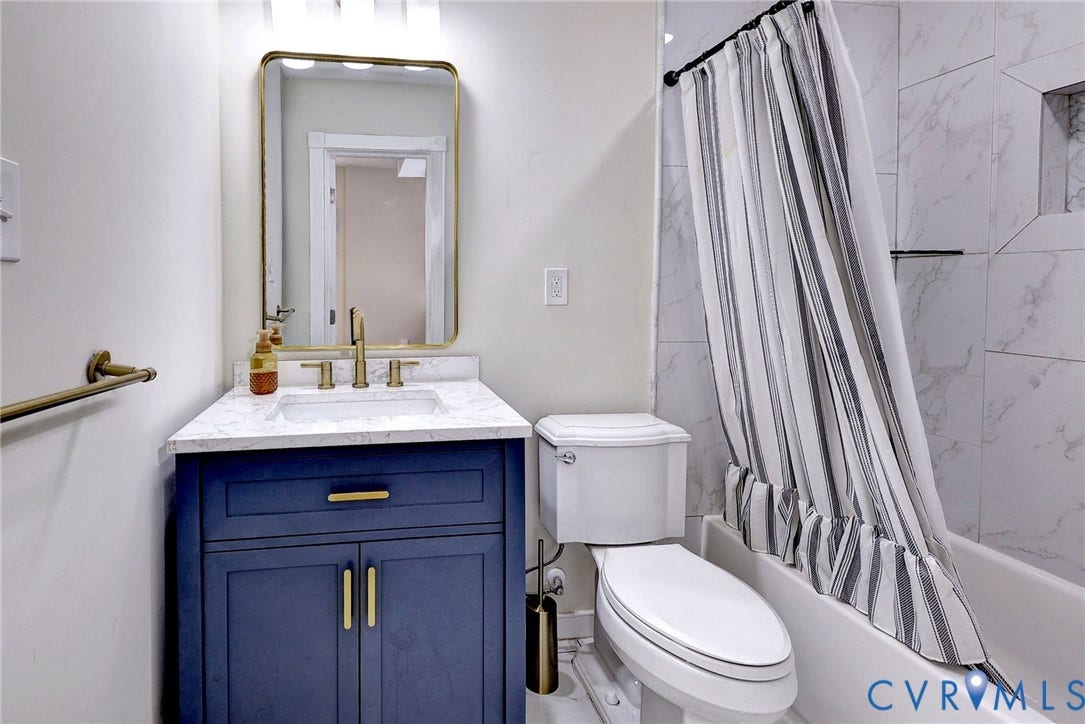 730 N 23RD Street, Union Hill, Richmond, VA 23223 First floor FULL bath featuring vanity with quartz countertop, undermount sink, brass-tone hardware and tile surround tub/shower.