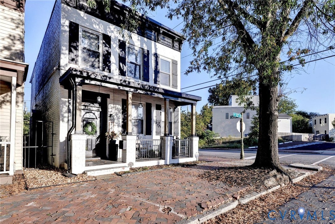 730 N 23RD Street, Union Hill, Richmond, VA 23223 Two-story painted brick exterior featuring a covered front porch, decorative shutter accents, and a herringbone-patterned brick walkway