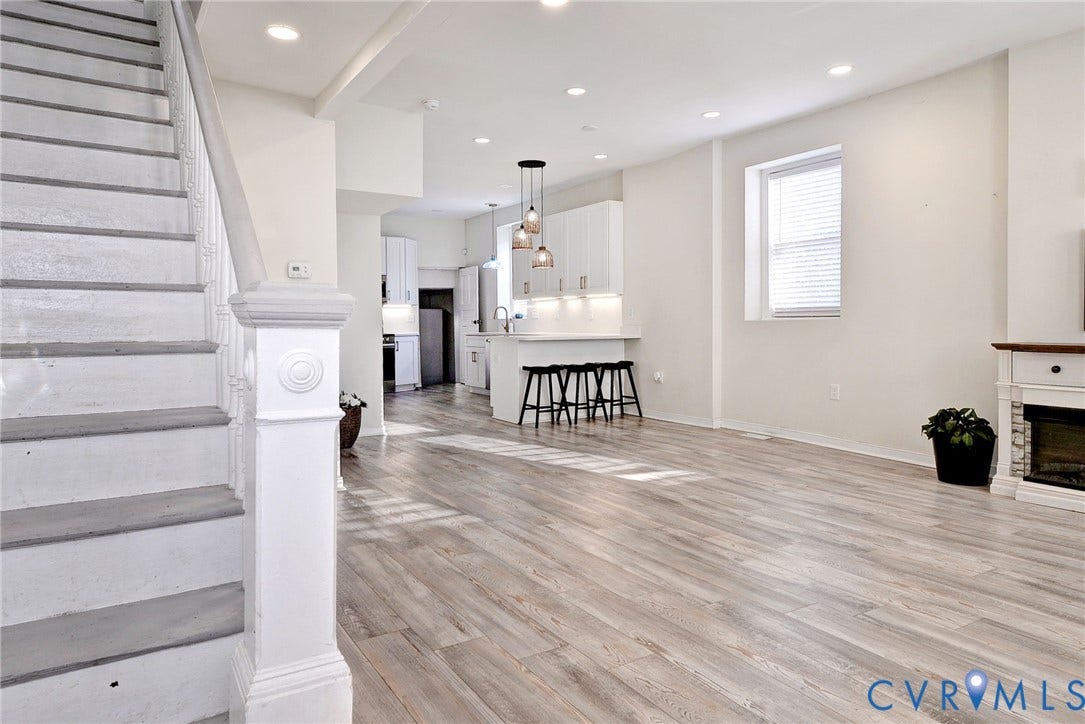730 N 23RD Street, Union Hill, Richmond, VA 23223 Open-concept interior featuring recessed lighting, electric fireplace, dining area and a kitchen with white cabinetry and a peninsula for extra seating.