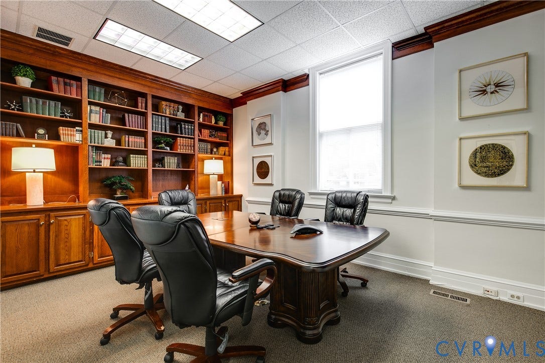 2800 Patterson Avenue, Richmond, VA 23221 Custom floor-to-ceiling wood cabinetry with integrated shelving, crown molding, chair rail trim, and a recessed window