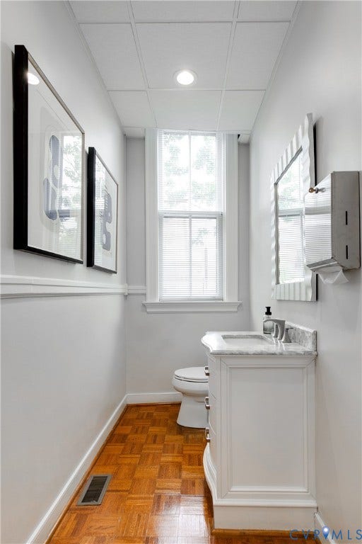 2800 Patterson Avenue, Richmond, VA 23221 Bathroom featuring a parquet wood-finish floor, white vanity with a stone countertop, recessed lighting, and a double-hung window
