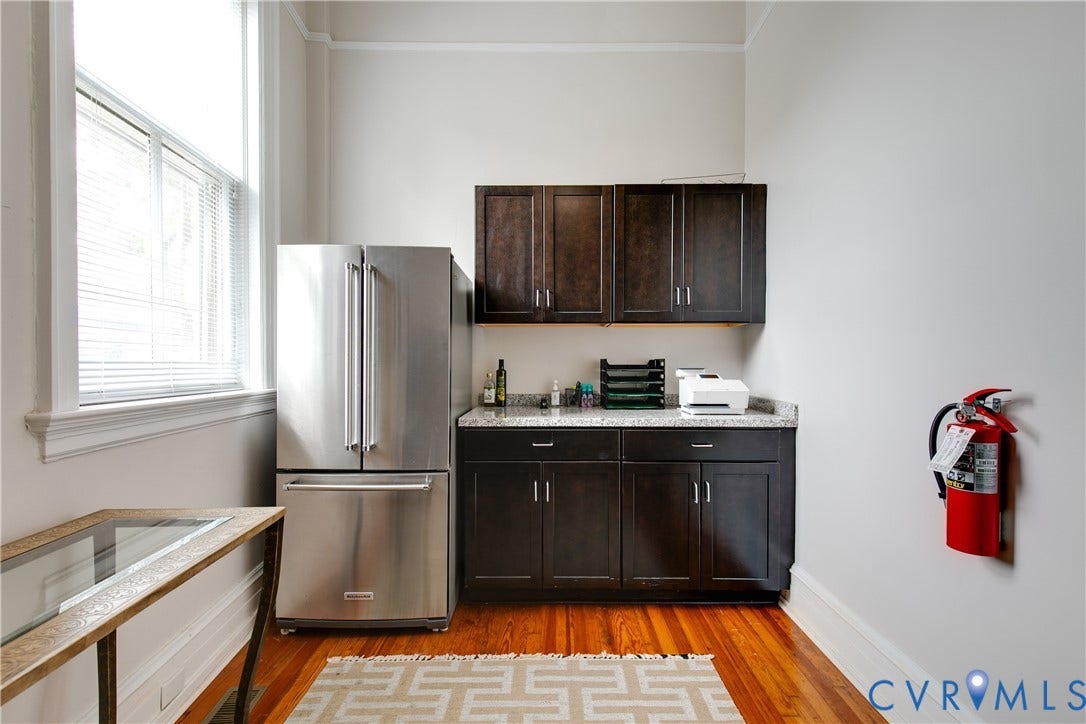 2800 Patterson Avenue, Richmond, VA 23221 Dark-stained wooden cabinetry, stone-finish countertops, stainless steel refrigerator, and wood-finish flooring